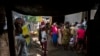 A mental health worker speaks to a small crowd of internally displaced people at a local church in the Delmas district of Port-Au-Prince, Haiti, June 11, 2024.