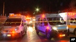 An image taken from a video shows ambulances and rescue teams staffers at the site of a fire at an immigration detention facility in Ciudad Juarez, Mexico, March 28, 2023.