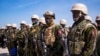 Members of a police force from Kenya stand on the tarmac of Toussaint Louverture International Airport after landing in Port-au-Prince, Haiti, June 25, 2024. 