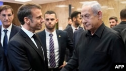 Israeli Prime Minister Benjamin Netanyahu shakes hands with French President Emmanuel Macron after their joint press conference in Jerusalem on October 24, 2023. 