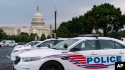 FILE - Washington Metropolitan Police vehicles hold on the perimeter of the Capitol in Washington, Aug. 26, 2021. 