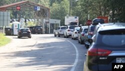 Cars line up at the border crossing between Lithuania and Belarus, Aug. 12, 2023. Next week, Lithuania will shut two out of its six existing border checkpoints with Belarus.