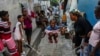 A girl plays a jump rope game at a school housing residents displaced by gang violence in Port-au-Prince, Haiti, May 15, 2024.