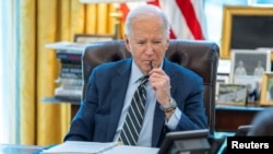 U.S. President Joe Biden speaks on the phone with Israeli Prime Minister Benjamin Netanyahu in this White House handout image taken in the Oval Office in Washington, April 4, 2024. 