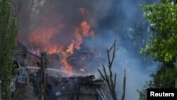 A rescuer works at a site of a clinic heavily hit by a Russian missile strike in Dnipro, Ukraine May 26, 2023.