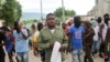 FILE - Gang leader and former police officer Jimmy "Barbecue" Cherizier leads a march against Haiti's Prime Minister Ariel Henry, in Port-au-Prince, Haiti, Sept. 19, 2023. 