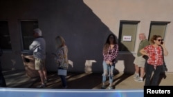 Voters wait in line to cast their ballots in the midterm elections in the Maricopa County town of Cave Creek, Arizona, Nov. 8, 2022. 