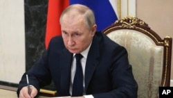 In this file photo, Russian President Vladimir Putin chairs a meeting with members of the government via teleconference in Moscow, Thursday, March 10, 2022. (Mikhail Klimentyev, Sputnik, Kremlin Pool Photo via AP, File)