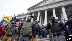 FILE - Members of the Oath Keepers on the East Front of the U.S. Capitol on Jan. 6, 2021, in Washington.