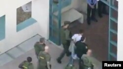 Cảnh sát dẫn nghi phạm Nikolas Cruz vào nhà tù Broward, ngày 14/2/2018.