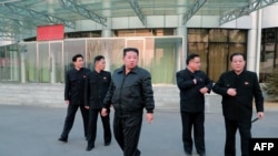 This undated picture released from North Korea's official Korean Central News Agency (KCNA) on March 10, 2022, shows North Korean leader Kim Jong Un, center, inspecting North Korea's National Aerospace Development Administration in Pyongyang.