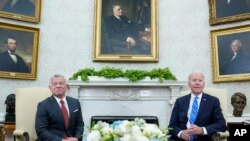 President Joe Biden, right, meets with Jordan's King Abdullah II, left, in the Oval Office of the White House in Washington, Monday, July 19, 2021. (AP Photo/Susan Walsh)