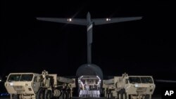  In this photo provided by U.S. Forces Korea, trucks carrying U.S. missile launchers and other equipment needed to set up the Terminal High Altitude Area Defense (THAAD) missile defense system arrive at the Osan air base in Pyeongtaek, South Korea, March 