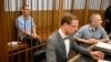 French citizen Laurent Vinatier sits in a cage behind his lawyers at the Zamoskvoretsky District Court in Moscow, Russia, Sept. 16, 2024. 