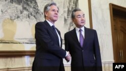 US Secretary of State Antony Blinken (L) shakes hands with China's Director of the Office of the Central Foreign Affairs Commission Wang Yi at the Diaoyutai State Guesthouse in Beijing on June 19, 2023. (Photo by Leah MILLIS / POOL / AFP)