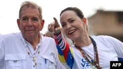 (FILES) Venezuelan opposition presidential candidate Edmundo Gonzalez Urrutia and opposition leader Maria Corina Machado attend a campaign a rally in Maracaibo, Zulia state, Venezuela on July 23, 2024.