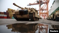 FILE PHOTO: Abrams tank from U.S. 2nd Armored Brigade Combat Team (ABCT) military equipment is unloaded in the Polish port of Gdynia