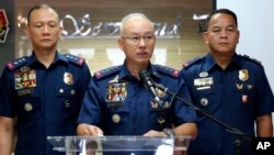 Director General Oscar Albayalde, center, Chief of the Philippine National Police at Camp Crame in suburban Quezon city northeast of Manila, Philippines, , Monday, Feb. 4, 2019.