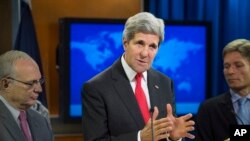 Secretary of State John Kerry (center) speaks at the State Department in Washington, D.C., during a news conference to announce the 2013 Annual Report on International Religious Freedom, July 28, 2014