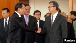 Thủ tướng Campuchia Hun Sen (trái) bắt tay với ông Sam Rainsy sau một cuộc họp tại Quốc hội Campuchia, ngày 16 tháng 9, 2013. 