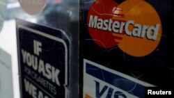 Biển hiệu một cửa hàng chấp nhận thẻ tín dụng Visa và Mastercard.