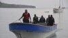 Jamaican Marine Police return to the Port Antonio Marina after a fruitless search for a plane that crashed into the ocean near Port Antonio, Jamaica, Sept. 5, 2014. 