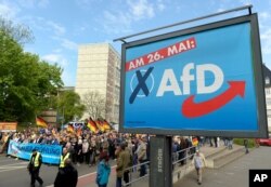 FILE - AfD supporters walk in Erfurt, Germany, May 1, 2019.