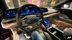 FILE - The dashboard of a Lucid Air electric vehicle sits on display inside a showroom in White Plains, New York, Feb. 9, 2023. 