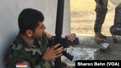 Chiến binh Peshmerga bên ngoài một ngôi nhà mới chiếm lại từ phe Hồi giáo cực đoan ở Mosul.