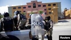 A Haitian National Police (PNH) officer walks towards a hotel, designated as a quarantine facility for the coronavirus disease (COVID-19), in Port-au-Prince, Haiti.