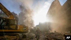 Rescue workers search for victims at the site of an Israeli airstrike in Beirut, Lebanon, Oct. 11, 2024. 