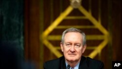 FILE - Chairman Mike Crapo, R-Idaho, listens during a Senate Banking Committee hearing on Capitol Hill, Dec. 1, 2020.