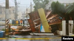 Căn nhà gỗ đổ sụp vì gió mạnh khi cơn bão Neoguri thổi vào Naha, mạn nam đảo Okinawa, 8/7/14