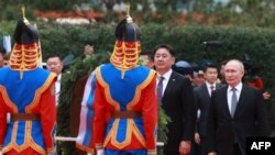 Russia's President Vladimir Putin (R) and Mongolia's President Ukhnaagiin Khurelsukh attend a wreath laying ceremony at a monument to Soviet Marshal Georgy Zhukov in Ulaanbaatar on September 3, 2024. (Photo by BYAMBASUREN BYAMBA-OCHIR / AFP)